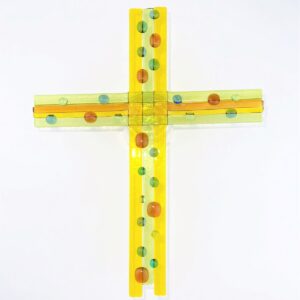 Yellow cross with multi-color 'pebbles'. Glass art by Betty